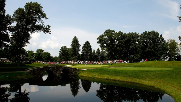 In the distance: Rickie Fowler, putting somewhere over there, finished on seven-under - eight shots shy of champion McIlroy