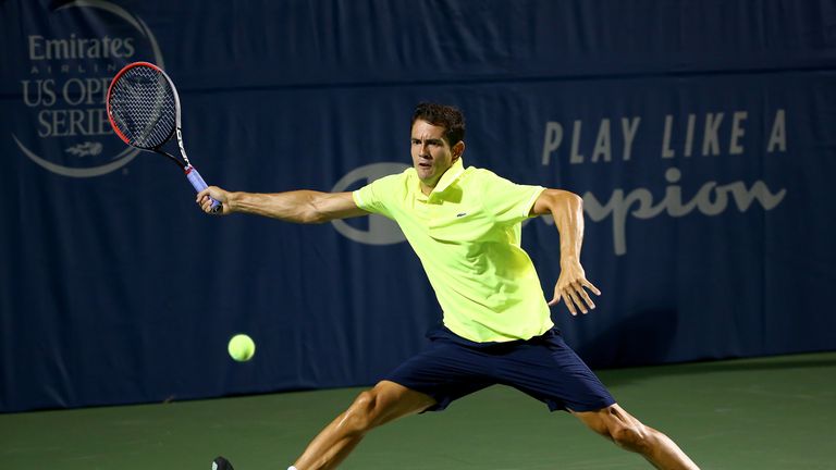 Guillermo Garcia-Lopez of Spain returns a shot to Dustin Brown of Germany during the Winston-Salem Open