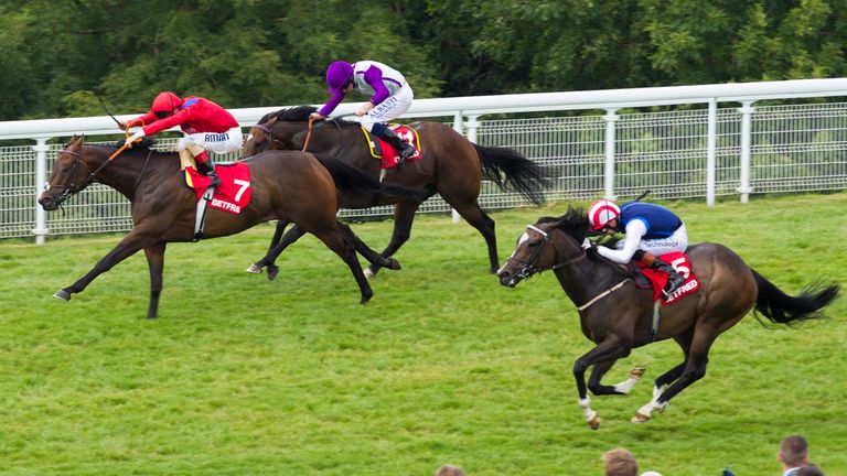 Take Cover ridden by Andrea Atzeni (7) wins the Betfred King George Stakes from Extortionist ridden Ryan Moore (11) during day four of Glorious Goodwood.