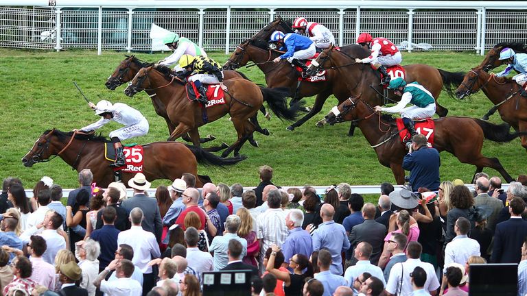 CHICHESTER, ENGLAND - AUGUST 02: Richard Hughes riding Intrinsic (no.25) wins The 32Red Cup at Goodwood racecourse on August 02, 2014 in Chichester, Englan