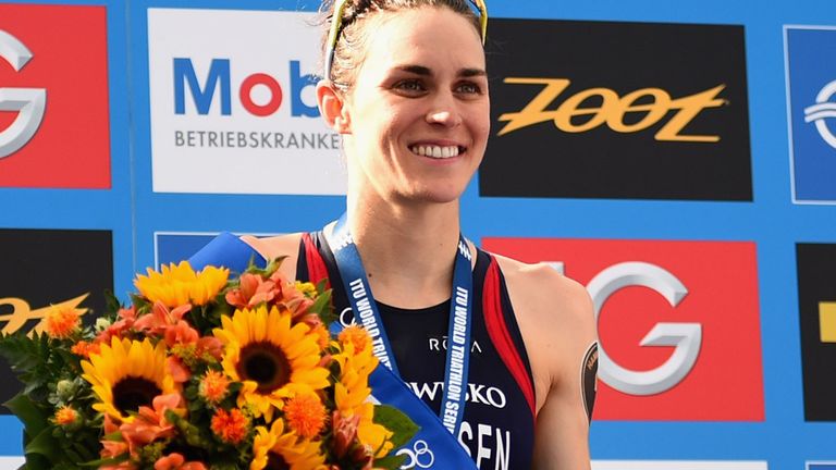 Gwen Jorgensen of the United States poses at the podium after the Women's ITU World Triathlon sprint event on July 12, 2014 in  Hamburg.