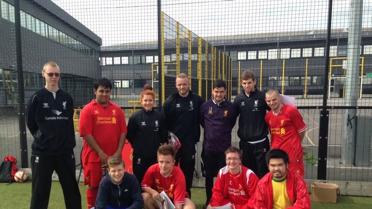 Jon Flanagan and fellow defender Ryan McLaughlin with members of the Liverpool Foundation summer camp