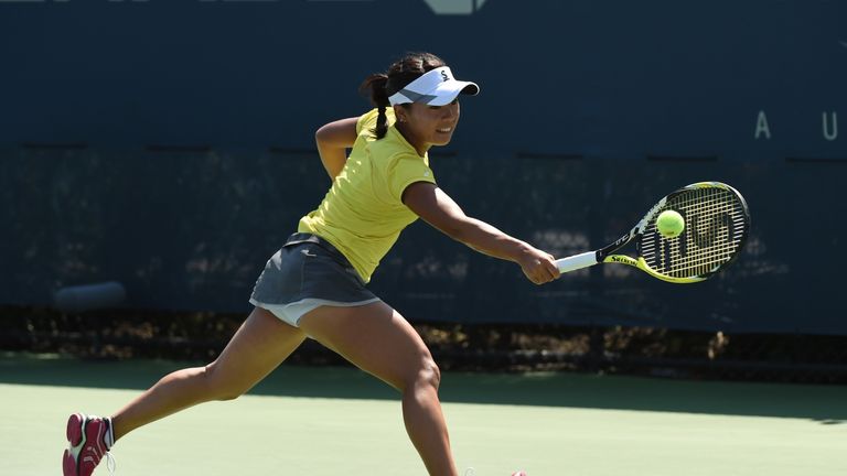 Kurumi Nara of Japan returns the ball against Belinda Bencic of Switzerland during their  2014 US Open match