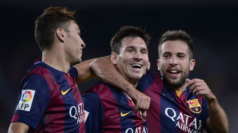 Lionel Messi (C) is congratulated by teammate defender Jordi Alba (R) and Barcelona forward Munir after scoring against Elche