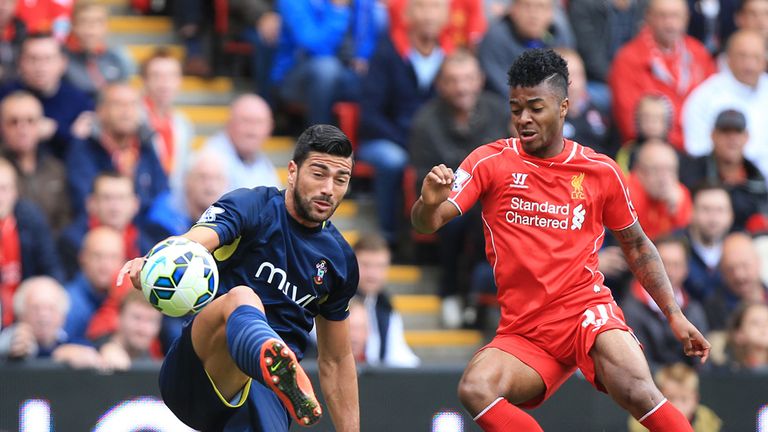 Graziano Pelle and Raheem Sterling battle for the ball 