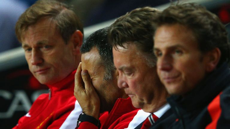 Assistant manager Ryan Giggs looks dejected with manager Louis van Gaal of Manchester United 