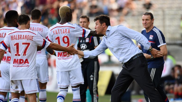Lyon's French midfielder Steed Malbranque (L) is congratuled by Lyon's French coach Hubert Fournier (R) after scoring