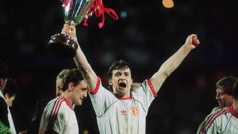 Welsh footballer Mark Hughes of Manchester United raises the European Cup Winners' Cup after his team beat Barcelona 2-1 in the final in 1991