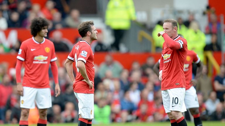 Manchester United's  Juan Mata and Wayne Rooney dejected at the restart after Swansea City score their second goal during