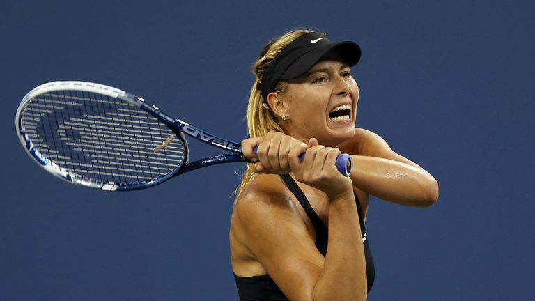 Maria Sharapova returns a shot against Maria Kirilenko  during her women's singles first round match on Day One of the US Open