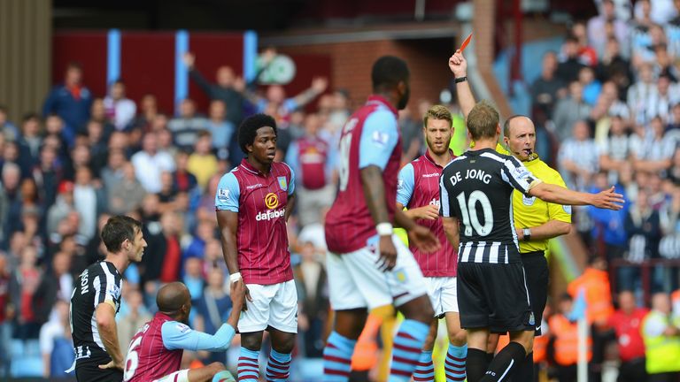 Newcastle defender Mike Williamson is shown the red card by referee Mike Dean after bringing down Fabian Delph in the 0-0 draw with Aston Villa