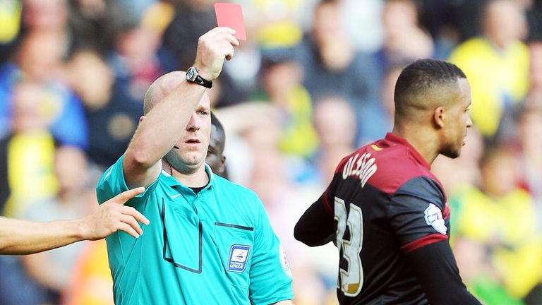Referee Simon Hooper dismisses Norwich defender Martin Olsson at Molineux