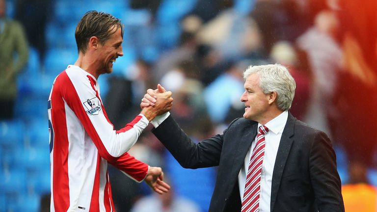 Peter Crouch of Stoke City celebrates victory with Mark Hughes
