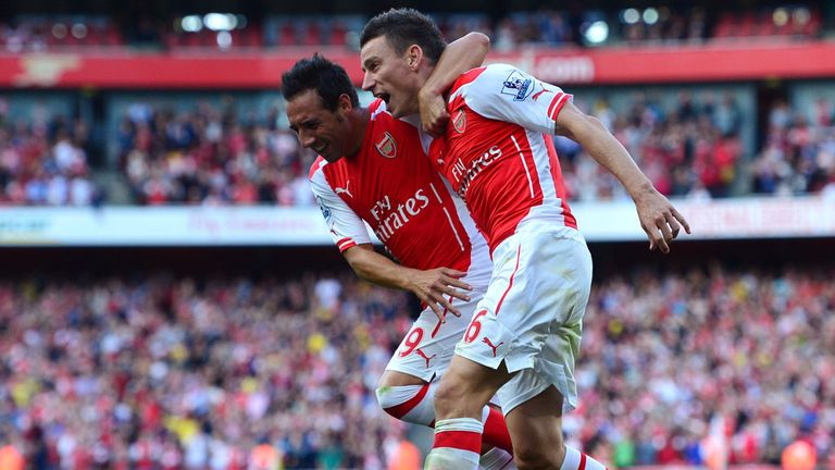 Arsenal's Laurent Koscielny celebrates with Santi Cazorla after scoring the equalising goal