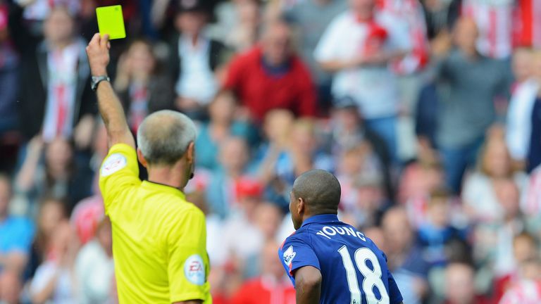 Manchester United winger Ashley Young has no arguments as referee Martin Atkinson books him for simulation.