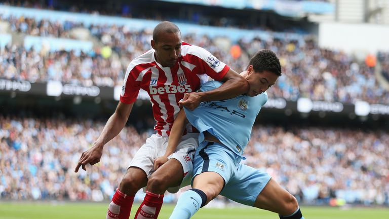 Steven N'Zonzi of Stoke City challenges Samir Nasri of Manchester City during the Barclays Premier League match at the Etihad Stadium