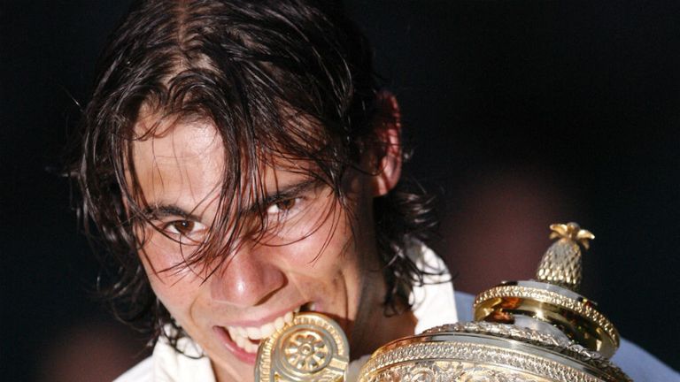 Rafael Nadal bites his trophy after defeating Roger Federer during the 2008 Wimbledon final