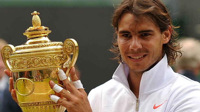 Rafael Nadal holds the Wimbledon Trophy as he poses for pictures after beating Czech Republic's Tomas Berdych in the 2010 Men's Singles Final