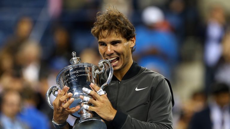 Rafael Nadal bites the US Open Championship trophy in 2013