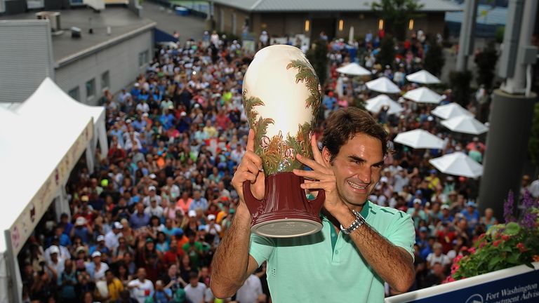 Roger Federer poses with the winner's trophy on Champion's Balcony after winning the Cincinnati Masters