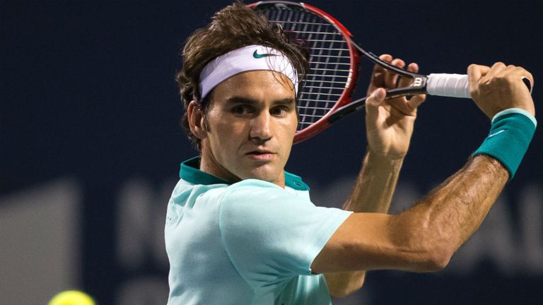 Roger Federer returns a shot to Feliciano Lopez during their Rogers Cup Toronto semi-final match