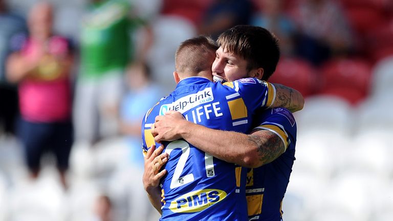 ST HELENS, ENGLAND - AUGUST 09: Tom Briscoe (R) of Leeds Rhinos is is congratulated by team-mate Liam Sutcliffe after going over for a try during the Tetle