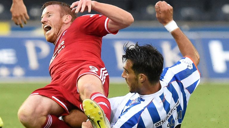 Kilmarnock's Manuel Pascali (r) slides in on Adam Rooney at Rugby Park