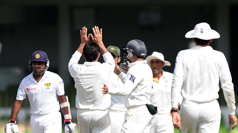 Saeed Ajmal (back) celebrates the wicket of Mahela Jayawardene (left). Colombo, August 14 2014.
