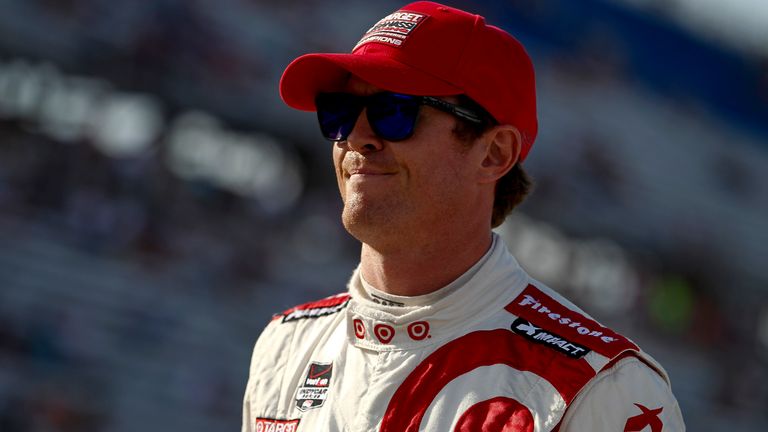 Scott Dixon stands on the grid during qualifying