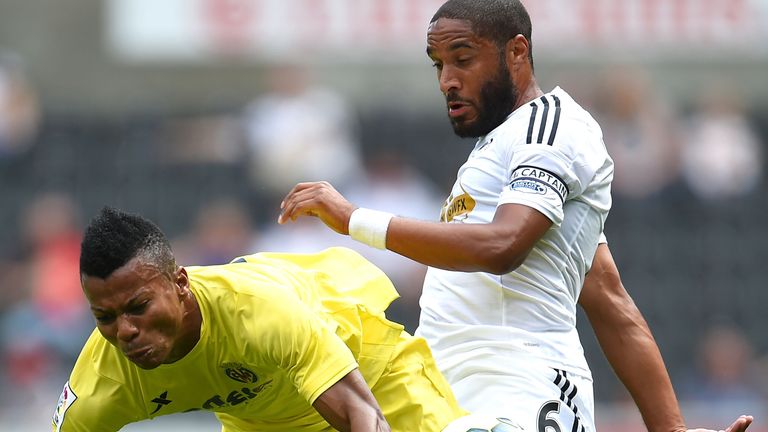 Ikechukwu Uche of Villarreal and Ashley Williams of Swansea City battle for the ball during a pre season friendly match between