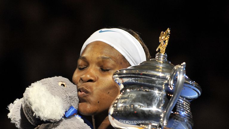 Serena Williams poses with a koala soft toy and the trophy after victory in the 2010 Australian Open