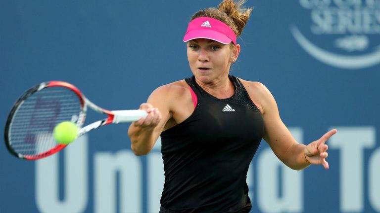 Simona Halep of Romania returns a shot to Magdalena Rybarikova of Slovakia during the Connecticut Open