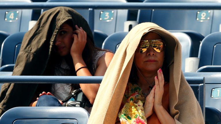 Fans shelter from the heat on Day Two of the 2014 US Open