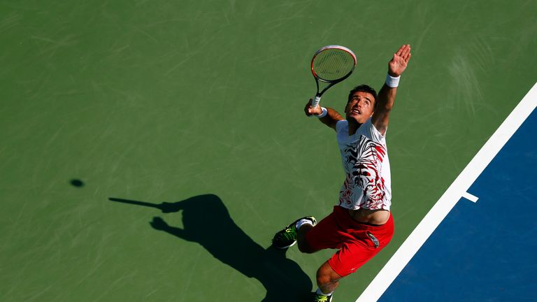 Ivan Dodig of Croatia serves against Feliciano Lopez of Spain at the US Open