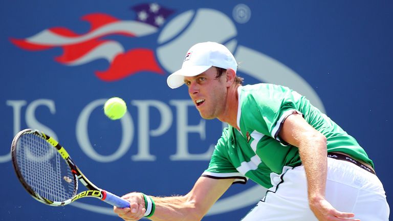 Sam Querrey of the United States returns a shot against Maximo Gonzalez of Argentina