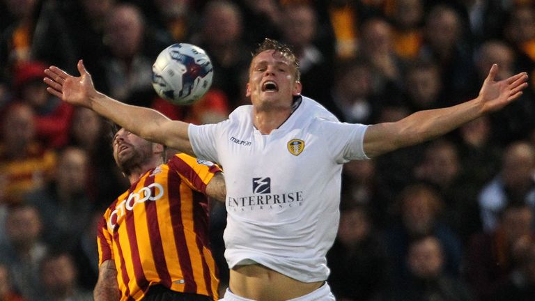 Leeds United's Billy Sharp and Bradford City's Alan Sheehan during the Capital One Cup Second Round match at Valley Parade, Bradford.