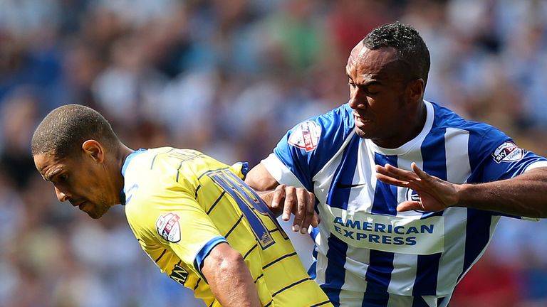Sheffield Wednesday's Giles Coke (left) is challenged by Brighton's Chris O'Grady during the Sky Bet Championship match at the AMEX Stadium, Brighton.