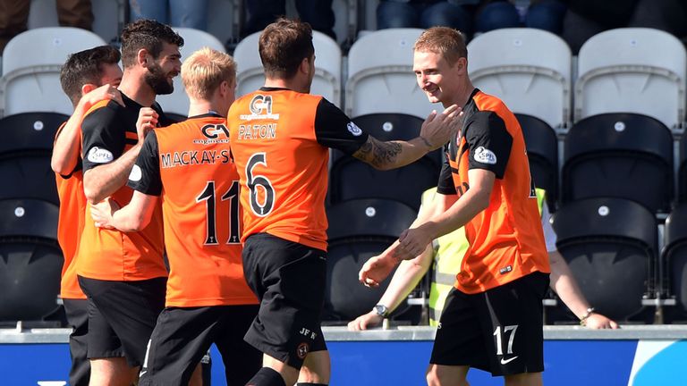 Dundee united's Chris Erskine (right) celebrates with team-mates after opening up the scoring against St Mirren