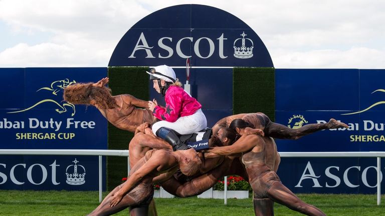 ASCOT, ENGLAND - JULY 29: A team of ten acrobats form the shape of a racehorse crossing the winning post ridden by Stefanie Hofer to celebrate the upcoming