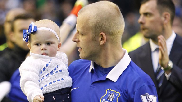Everton's Steven Naismith carries his daughter around Goodison Park following their final home game of the season in May