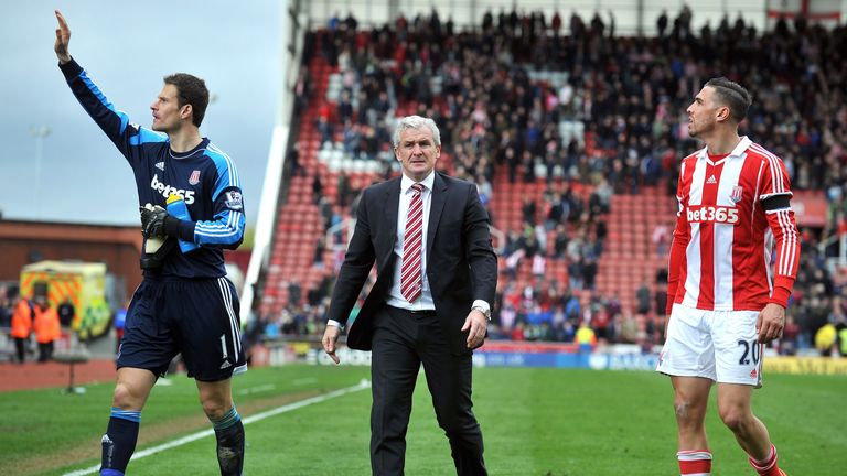 Stoke City's Welsh manager Mark Hughes (C) leaves the pitch with Stoke City's Bosnian goalkeeper Asmir Begovic (L) and Stoke City's US defender Geoff Camer