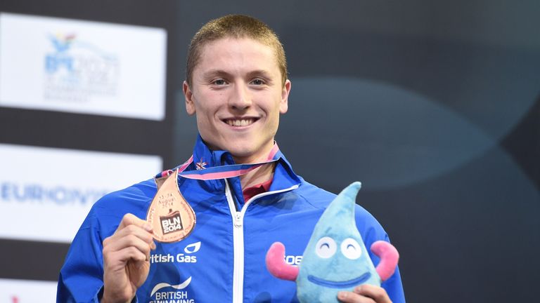 Roberto Pavoni celebrates with his bronze medal on the podium after the men's 200m Medley final at the European Swimming Championships