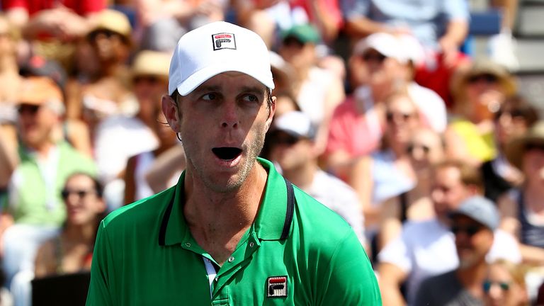 Sam Querrey of the United States reacts after winning a men's singles second round match against Guillermo Garcia-Lopez of Spain