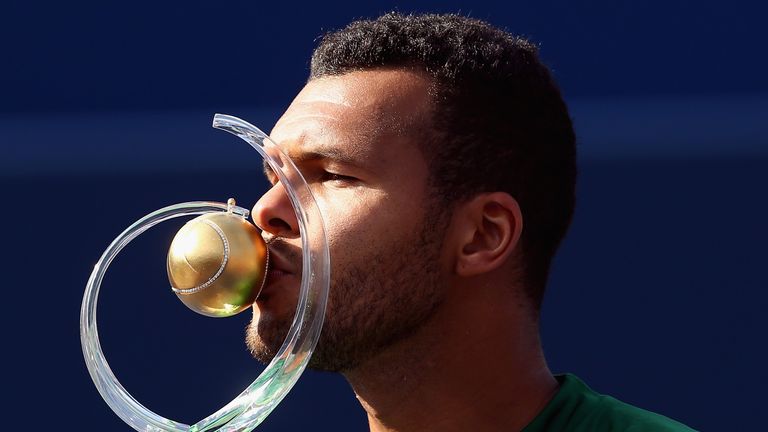 Jo-Wilfried Tsonga kisses the Rogers Cup trophy after his win against Roger Federer