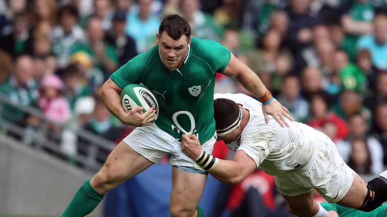 Cian Healy is tackled by Andrew Sheridan during the international match between Ireland and England in 2011