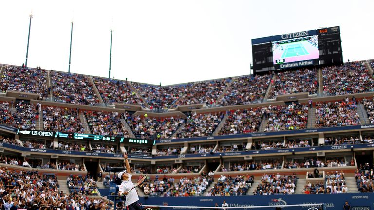 Kei Nishikori serves against Marin Cilic at Arthur Ashe Stadium