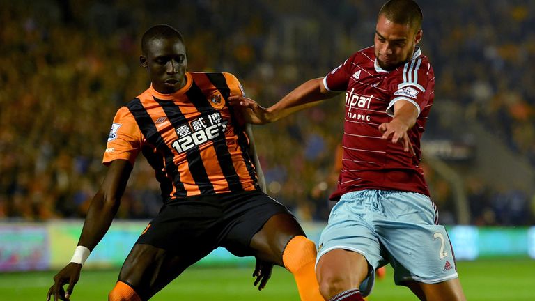HULL, ENGLAND - SEPTEMBER 15:  Hull striker Mohamed Diame (l) challenges Winston Reid of West Ham during the Barclays Premier League match between Hull Cit