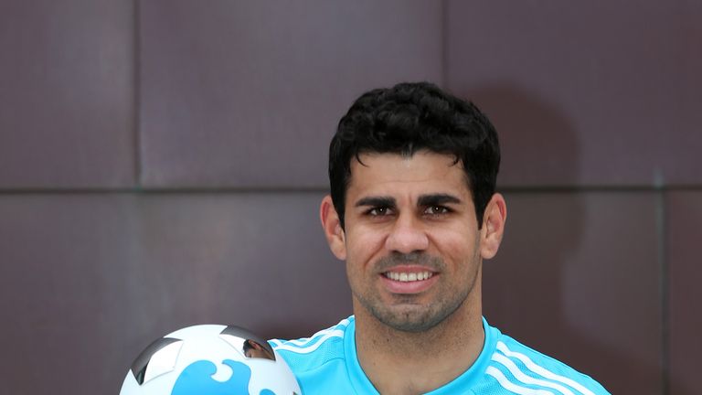 Chelsea striker Diego Costa celebrates with his Barclays Premier League Player of the Month award for August