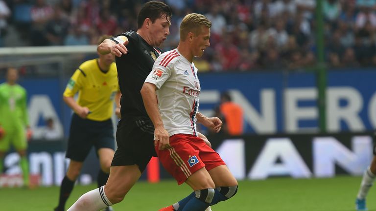 Pierre Emile Hojbjerg of Muenchen challenges for the ball with Matthais Ostrzolek of Hamburg during the Bundesliga match 