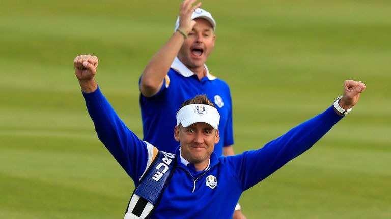 Ian Poulter raises his arms aloft after his half stopped US eating into Europe's margin of victory